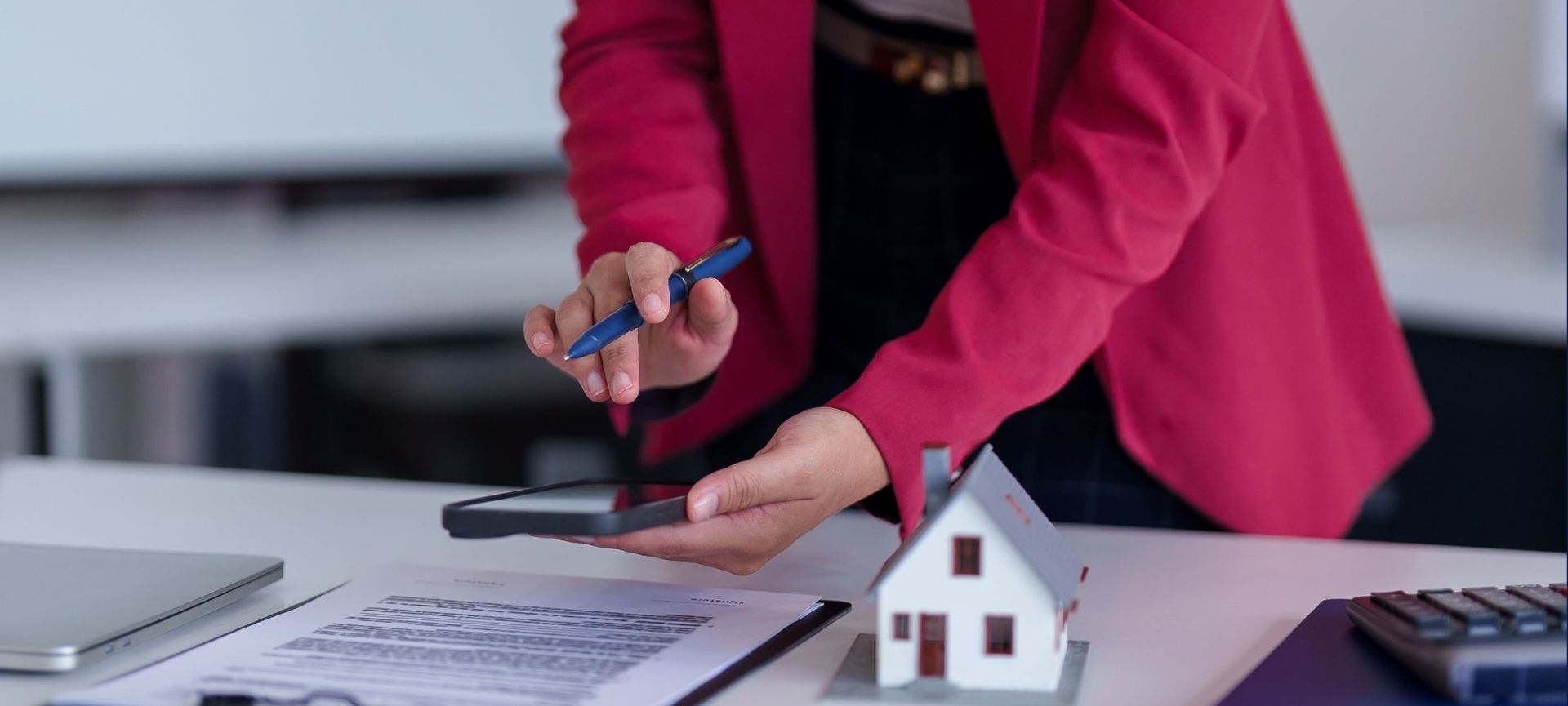 A property manager is working over a table next to a small house.