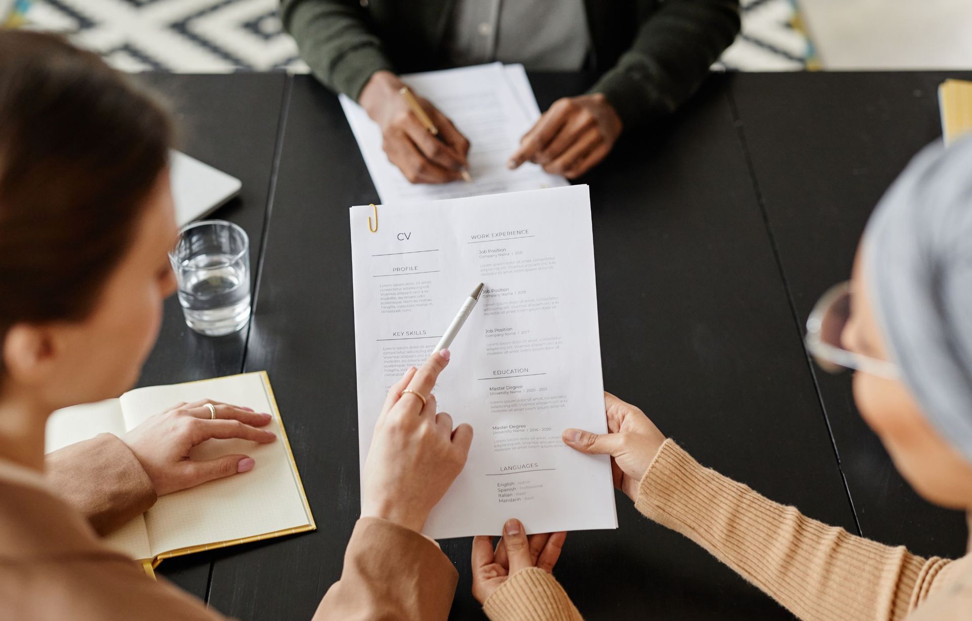 A group of people are sitting around a table looking at papers.