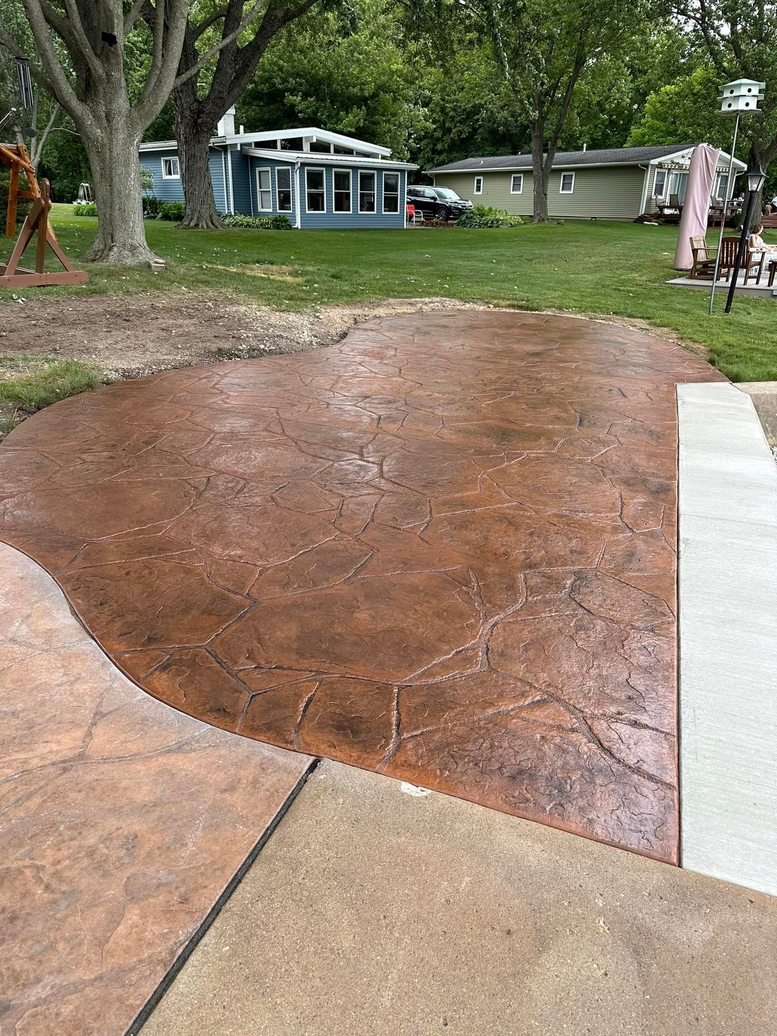 A blue house with a swimming pool in front of it