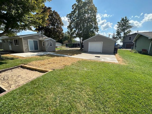 A house with a garage and a shed in the backyard