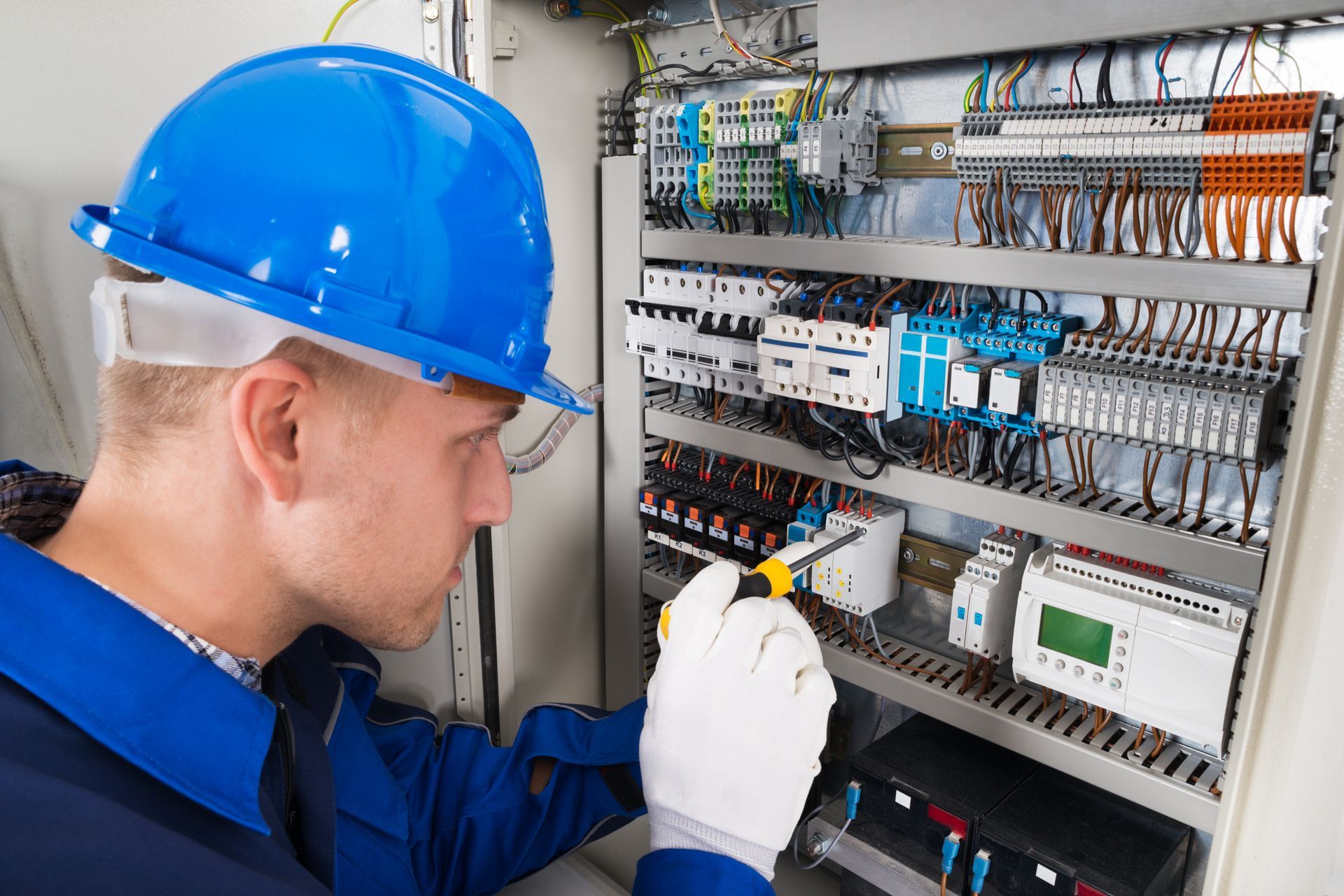 Electrician Examining Fusebox — Runcorn, QLD — Runcorn Electrical Services Pty Ltd