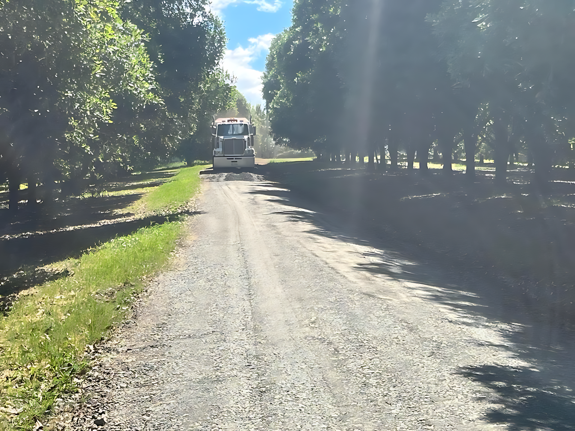 A truck is driving down a dirt road surrounded by trees — ZBM Constructions in Wollongbar, NSW