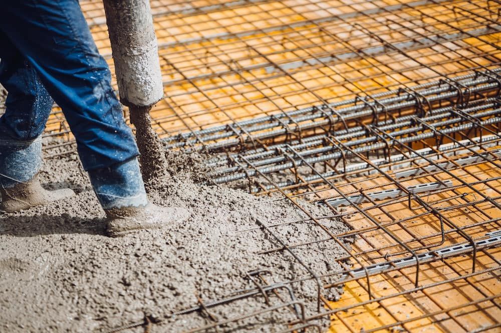A Man is Pouring Concrete on a Construction Site — ZBM Constructions in Alstonville, NSW
