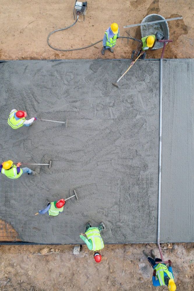 An Aerial View of a Group of Construction Workers Working on a Concrete Floor — ZBM Constructions in Alstonville, NSW