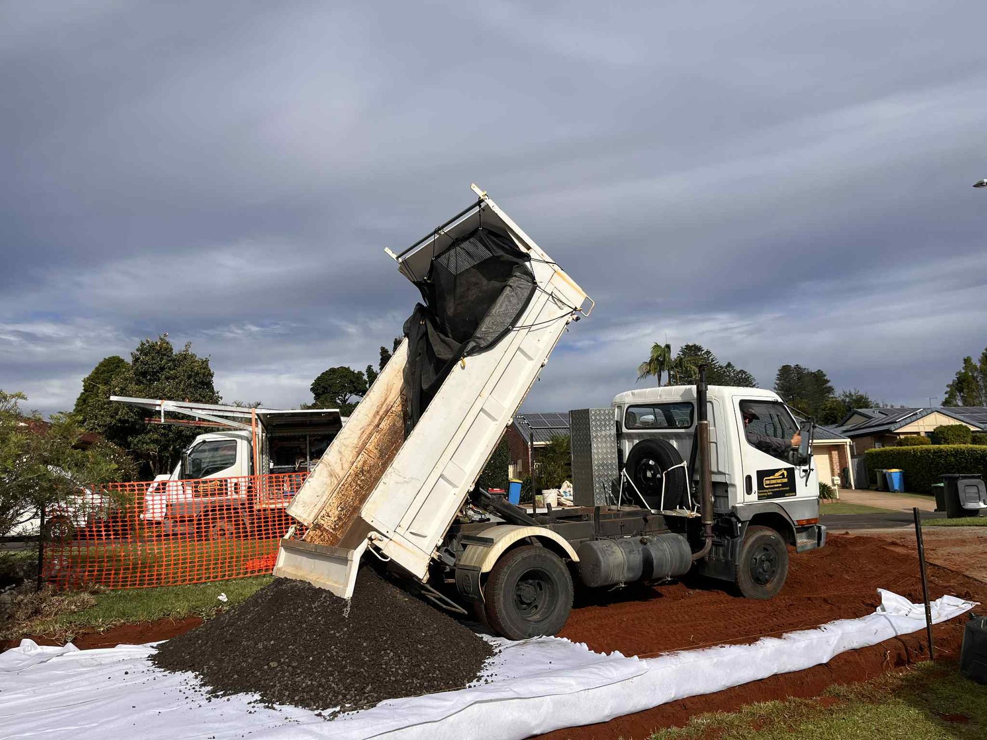 A dump truck is being loaded with dirt in a yard — ZBM Constructions in Wollongbar, NSW