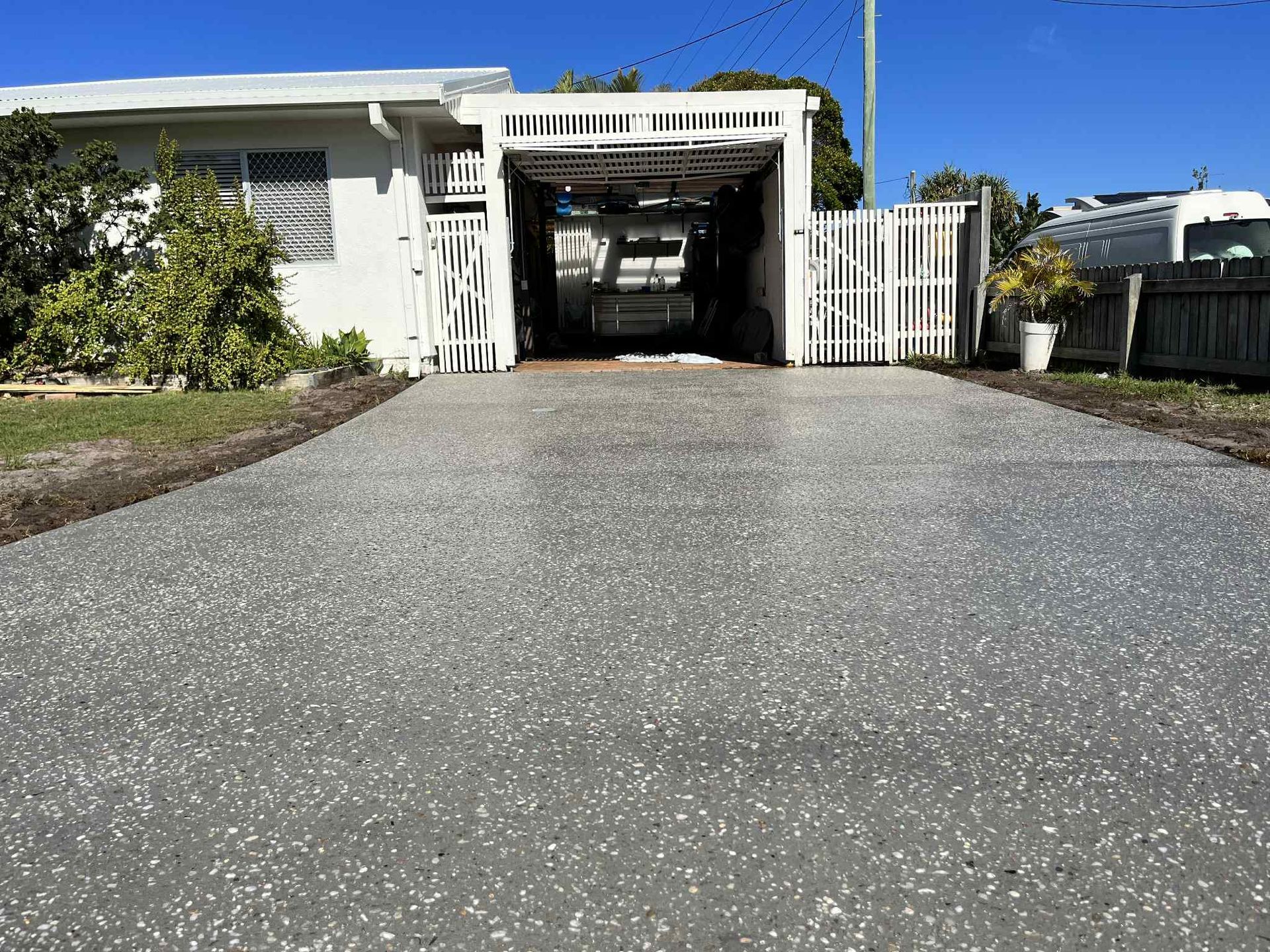 A car is parked in a driveway in front of a house — ZBM Constructions in Wollongbar, NSW