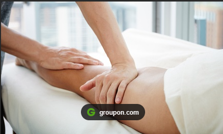 Woman shaking hands with a seated woman in an office setting. Both women are smiling.