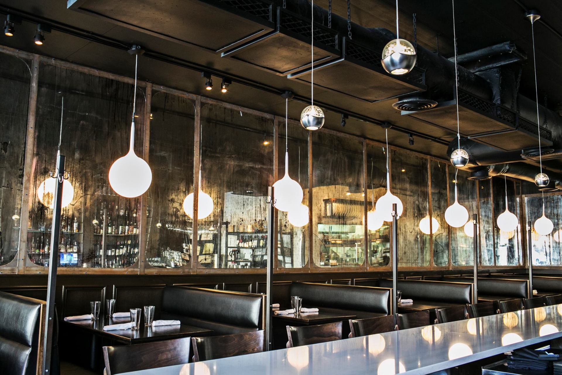 interior of 1920 Tavern in Roswell, with tables and chairs and a long bar