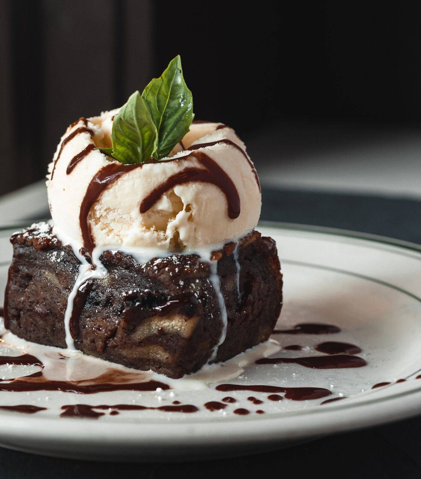 A brownie with a scoop of ice cream on top