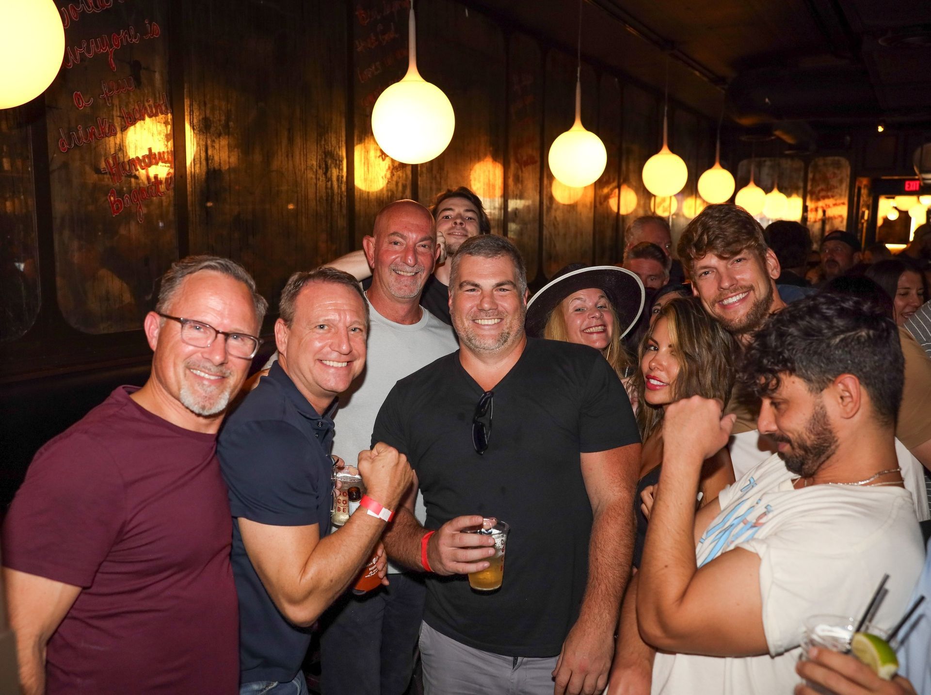 A group of people are posing for a picture at 1920 Tavern in Roswell GA.