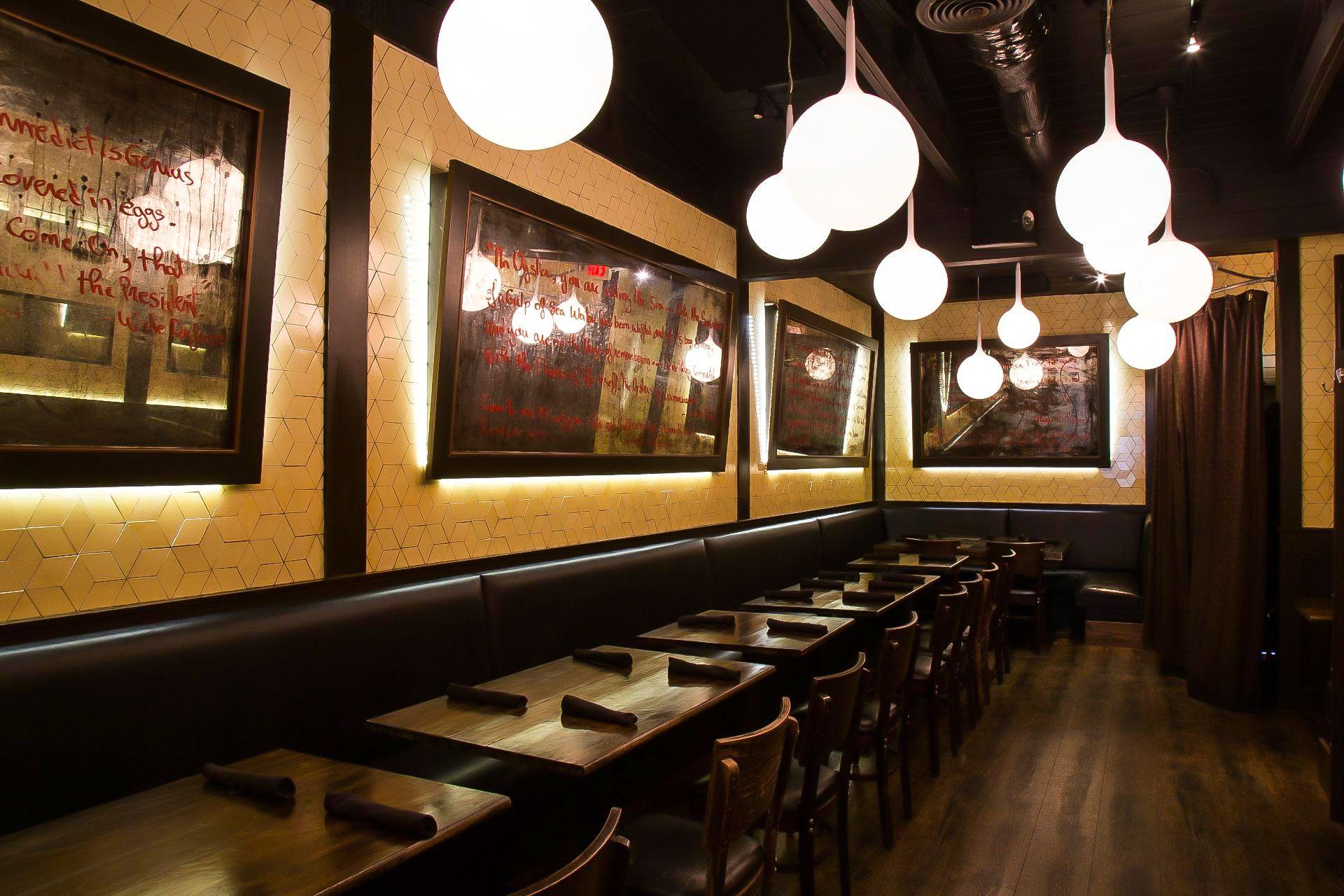 Insided the 1920 tavern with tables and chairs and a long couch