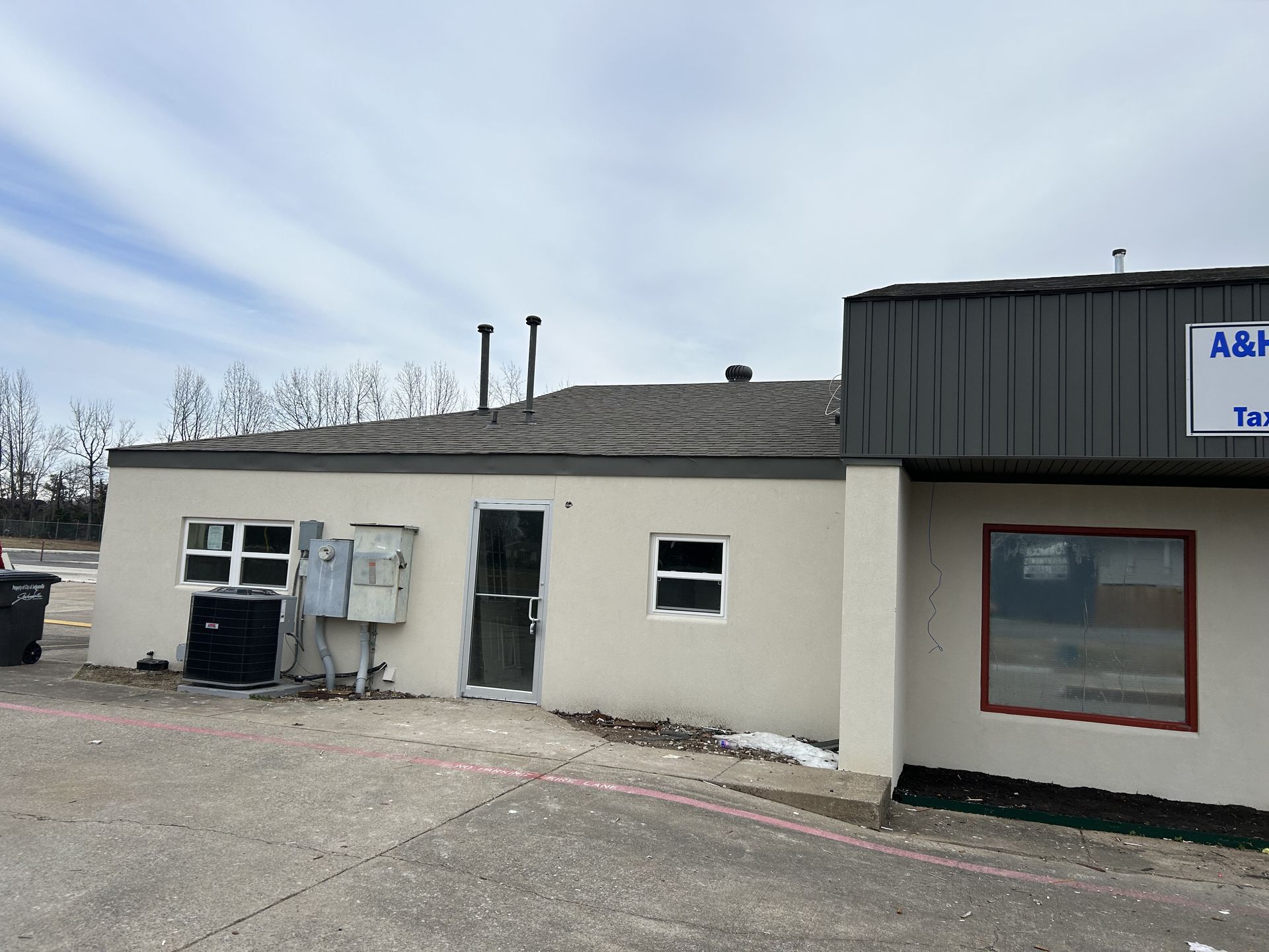 A building with a sign that says a & h on it