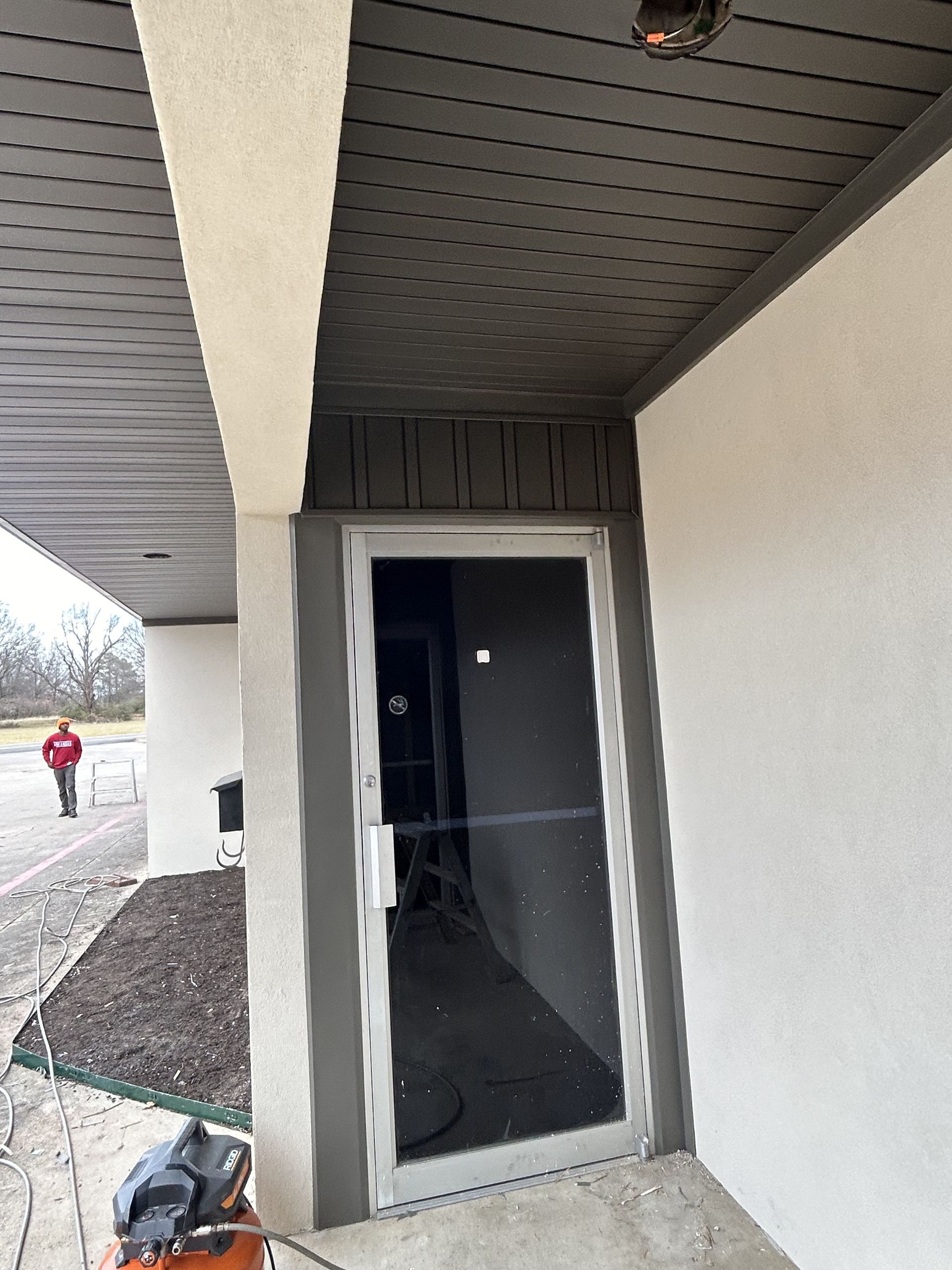 A door is being painted on the side of a building.