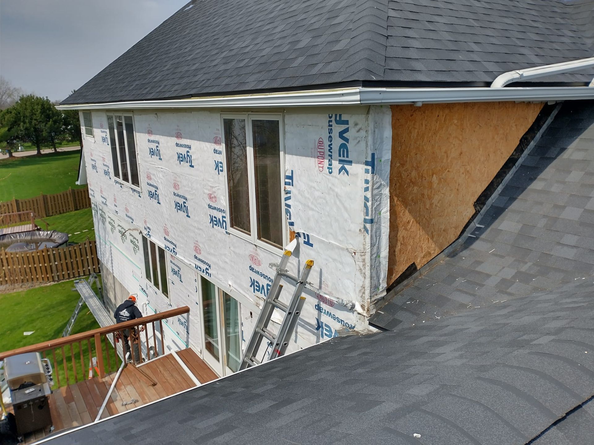 A house is being remodeled with a roof and a deck.