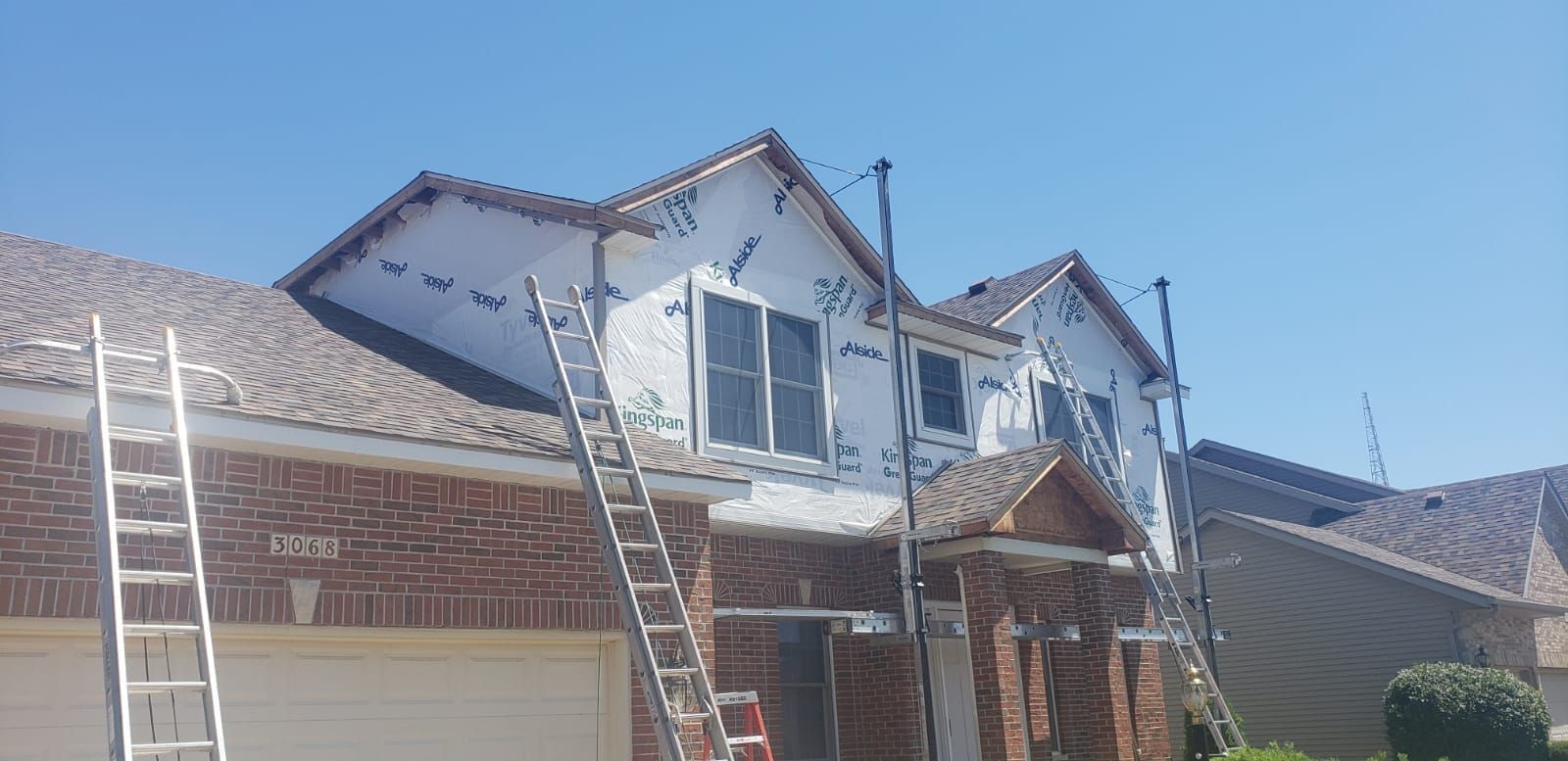 A house is being painted with a ladder attached to it.