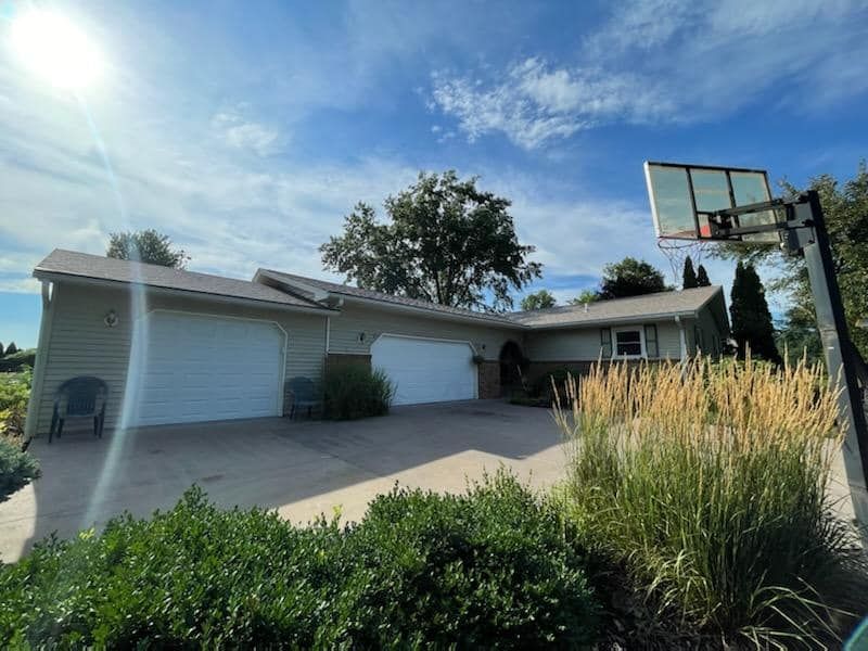 A house with a basketball hoop in front of it