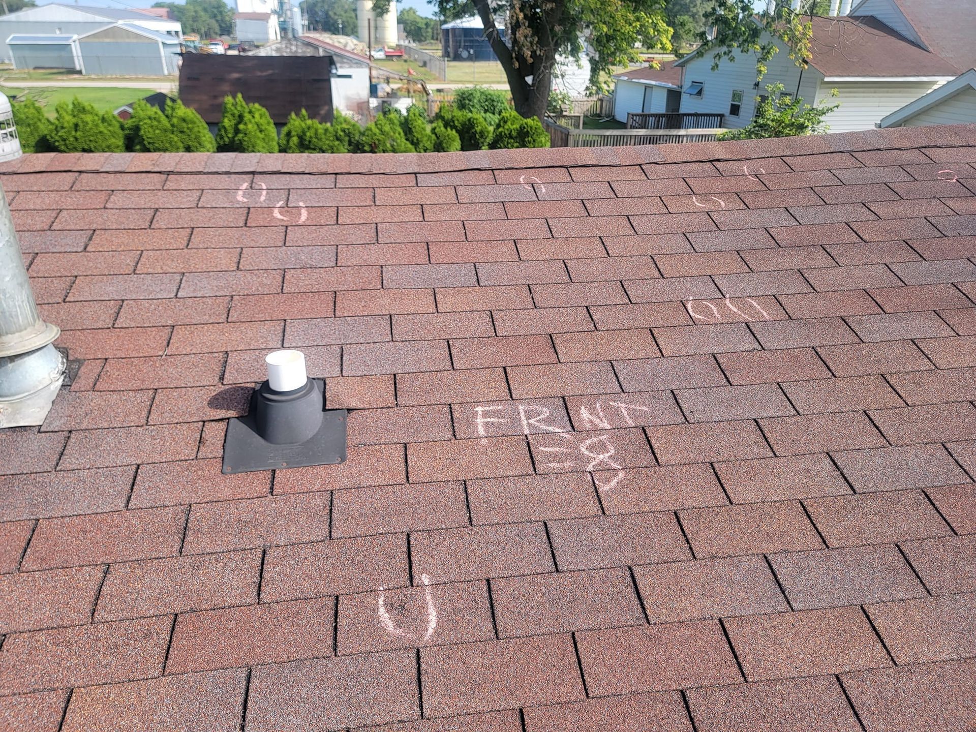 A roof with a chimney on it and the word front written in chalk.