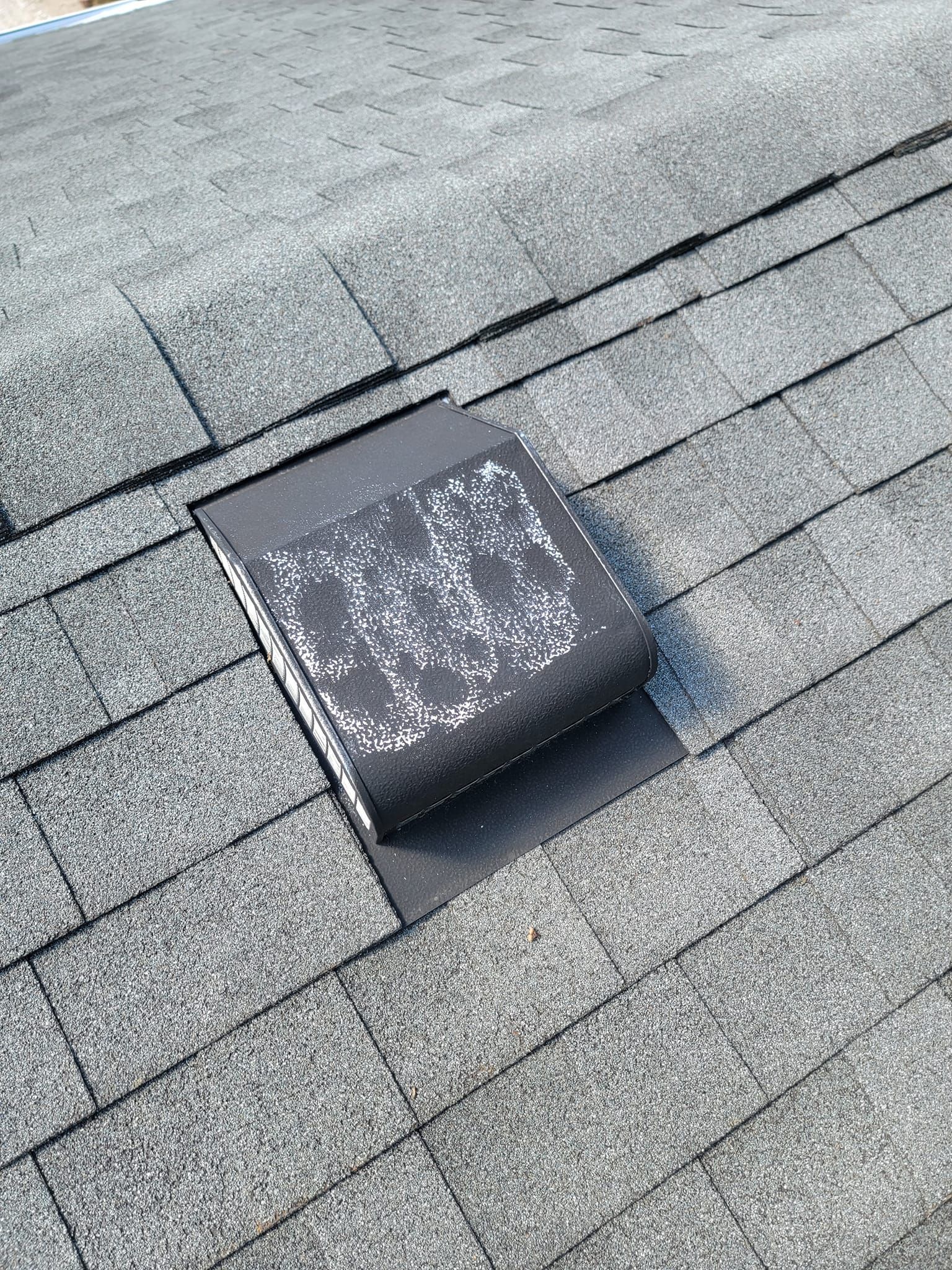 A close up of a roof with a vent on it.
