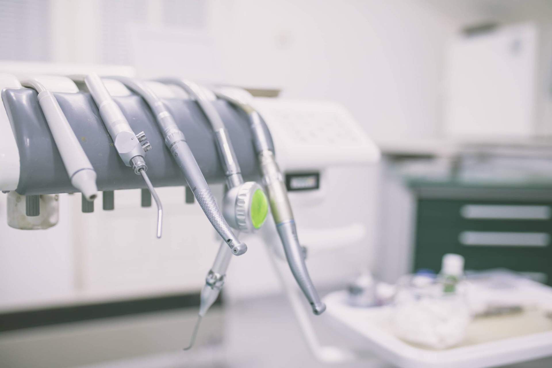 Dental tools hanging in a clean, bright dental office.