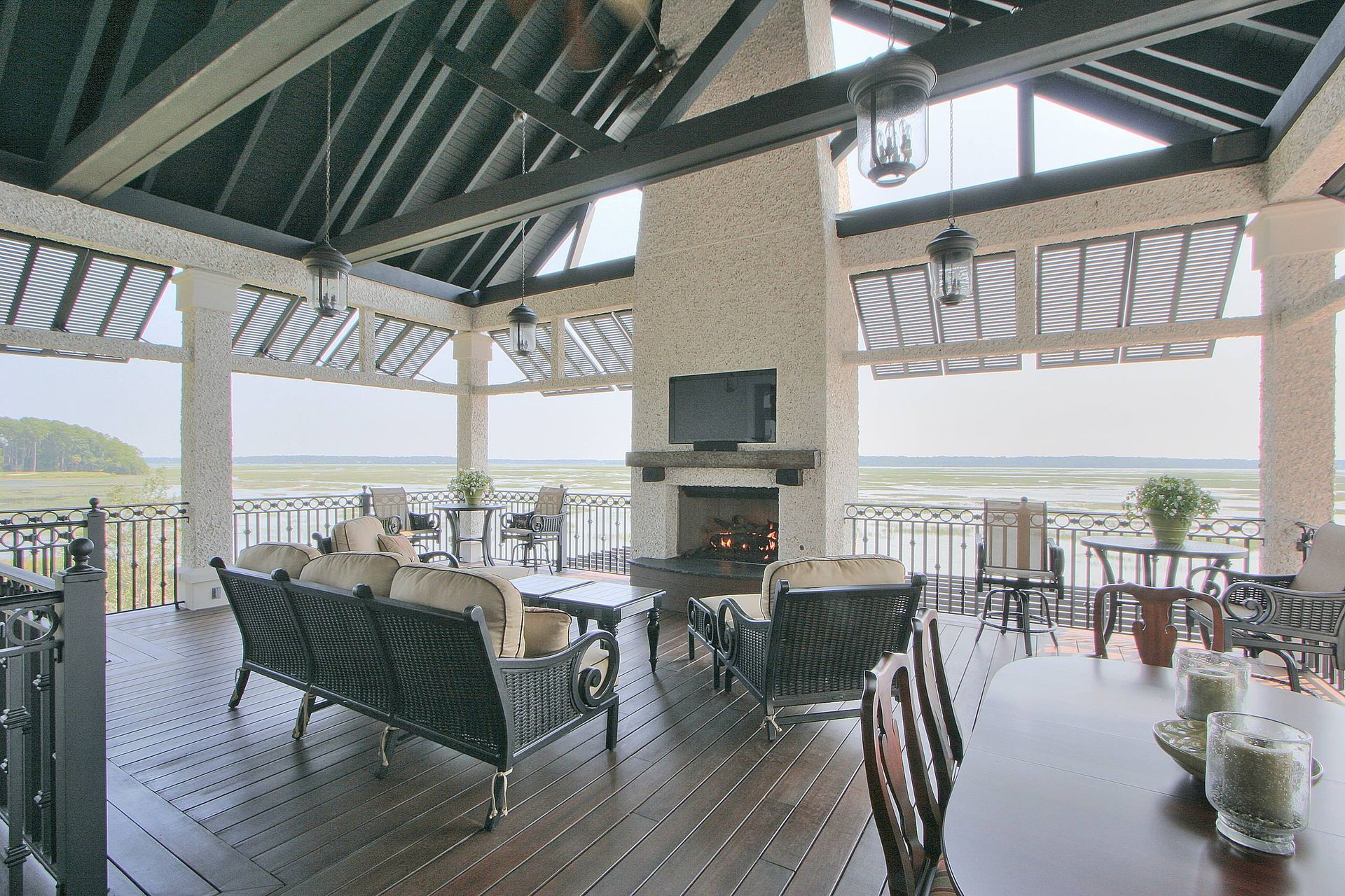A large room with a dining table and chairs and a fireplace