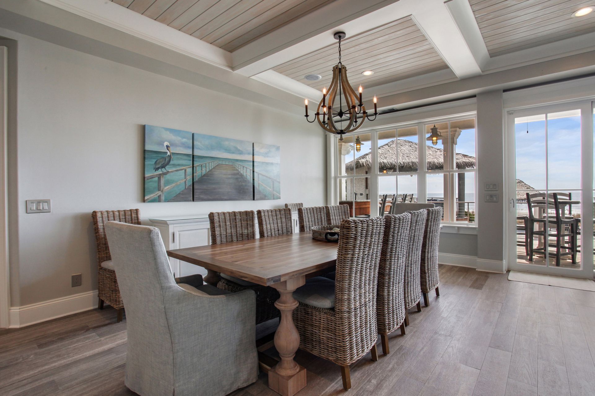 A dining room with a table and chairs and a chandelier.