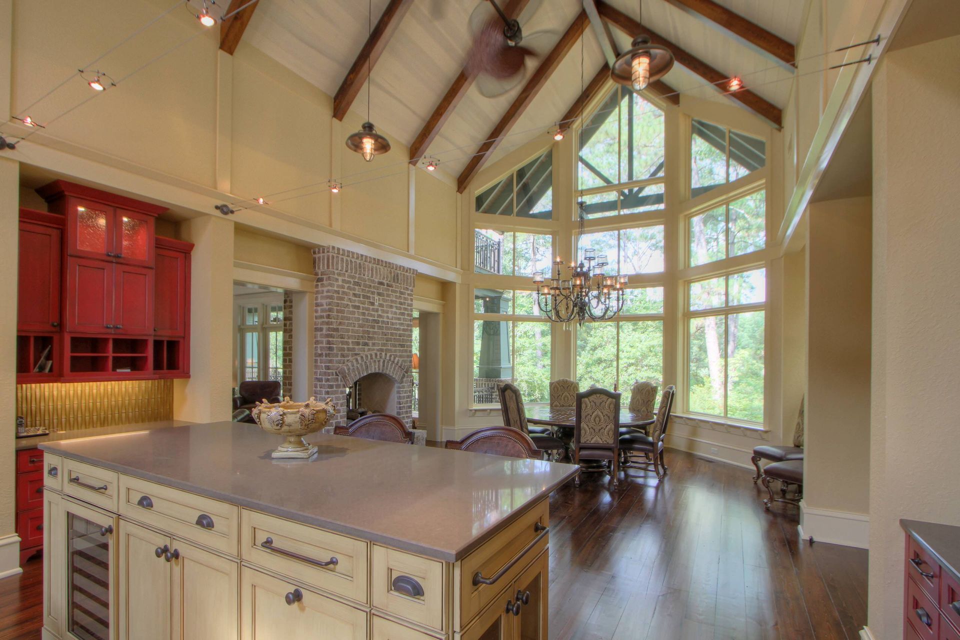 A kitchen and dining room in a house with a large island in the middle.