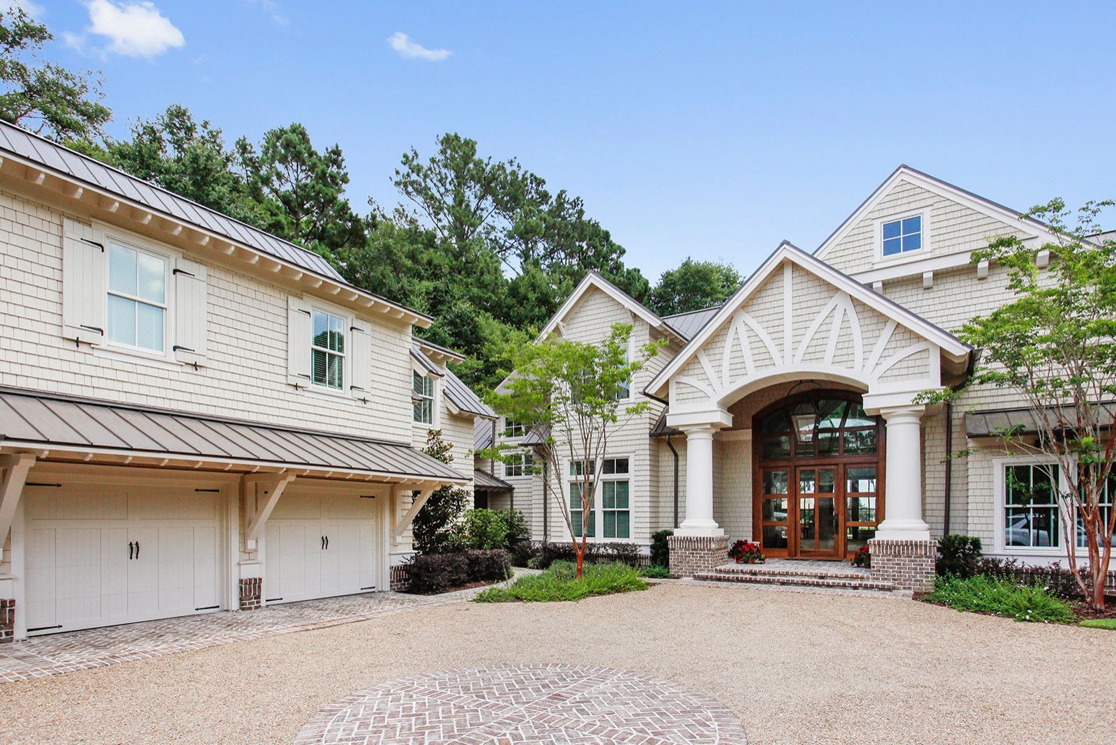 A large white house with two garages and a driveway