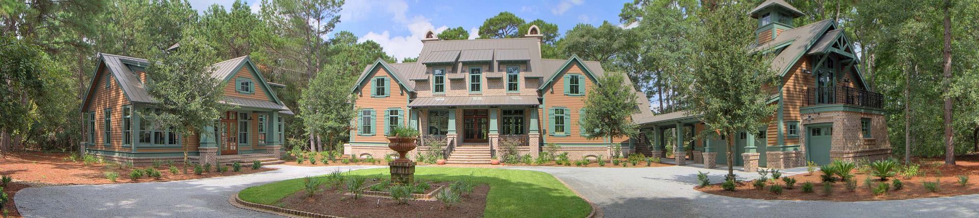 A large house is surrounded by smaller houses in a residential area.