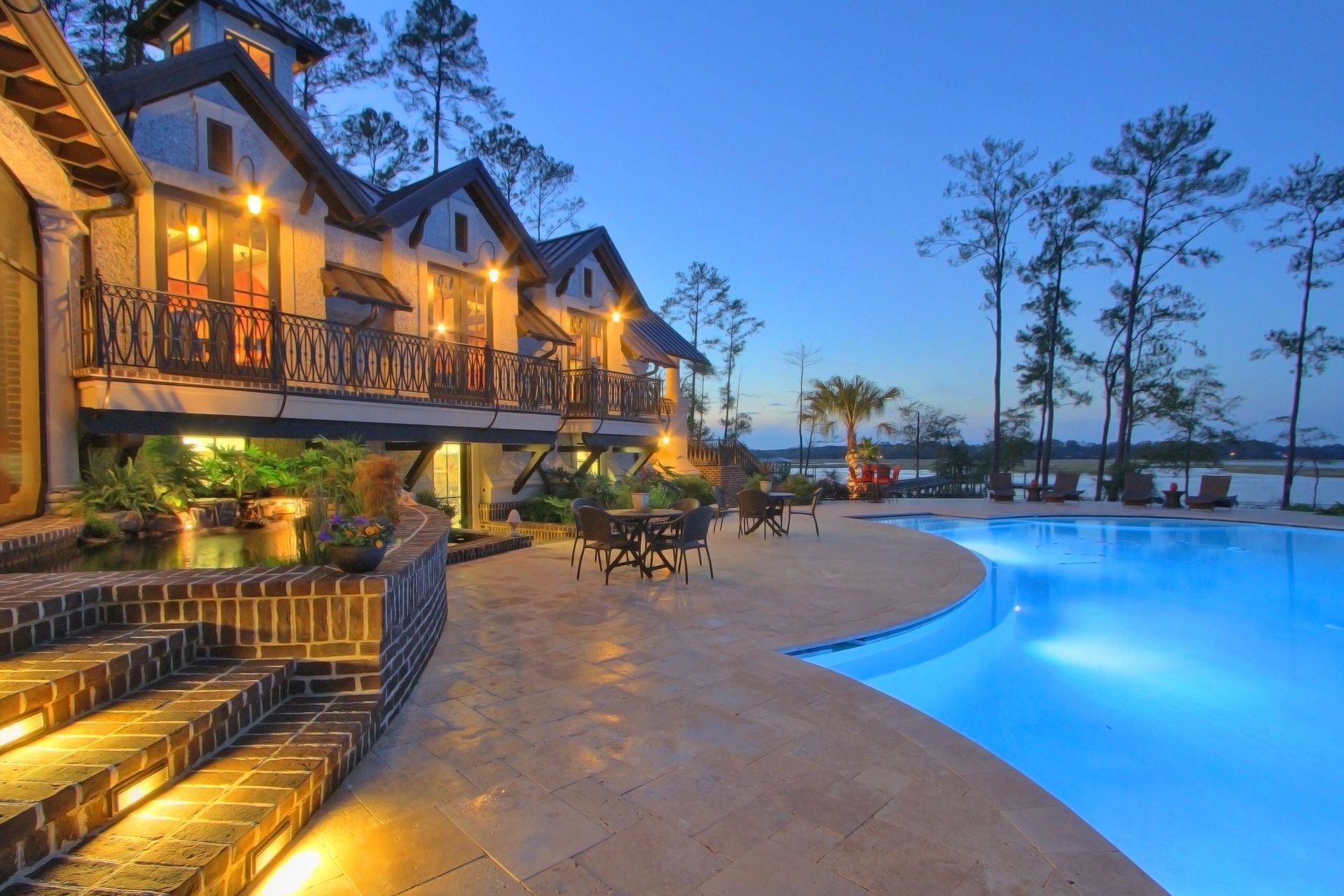 A large house with a swimming pool in front of it