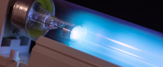 a close up of a uv light bulb with a blue light coming out of it .