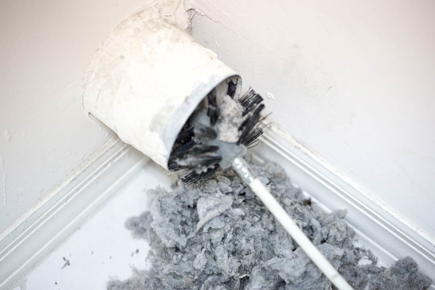 Using A Brush To Clean Dryer Vent