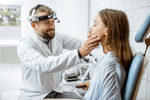 Otolaryngologist examining a patient