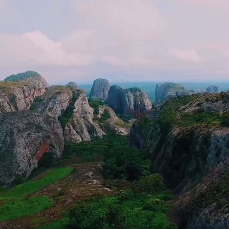 Angola offers diverse hiking experiences across its varied landscapes, from coastal cliffs to highland escarpments and desert terrain. The Tundavala Gap near Lubango provides panoramic views over dramatic cliffs, while Serra da Leba’s winding mountain roads lead to breathtaking viewpoints. Mount Moco, Angola’s highest peak, is a rewarding trek through montane forests and grasslands, home to rare bird species. The Pedras Negras de Pungo Andongo features giant rock formations steeped in history, ideal for exploration. With vast, uncharted trails, Angola remains a destination for adventurous hikers seeking raw and untouched nature.