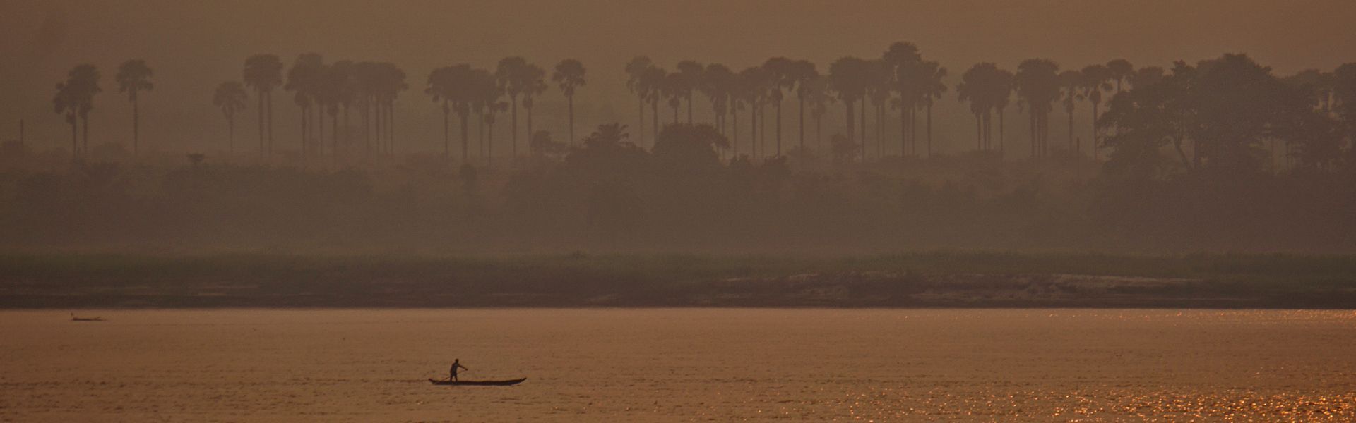 Experience the tranquil beauty of the Congo River at sunset. As the golden sun dips below the horizon, the river's gentle pace mirrors the serene flow of time. Picture a stunning landscape where the sky blazes with warm hues, reflecting off the water's surface in a breathtaking display. A lone fisherman in a traditional dugout canoe glides silently as the world slows down around him. The Congo River at sunset offers a mesmerizing escape, where nature's beauty and timeless traditions come together in perfect harmony.