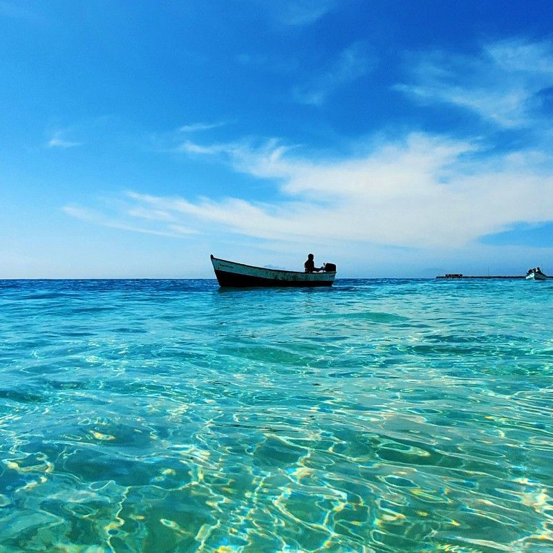 Immerse yourself in the purity of Cape Verde with this close-up photo of the stunning crystal clear turquoise water off a Maio beach. The vibrant hues of the ocean surround a picturesque sailboat anchored peacefully in the center, capturing the tranquility of this Atlantic island. Inspiration Africa specializes in designing your bespoke, tailor-made trip to Maio and other spectacular destinations across Africa. Plan your next unforgettable island and sailing getaway with us!