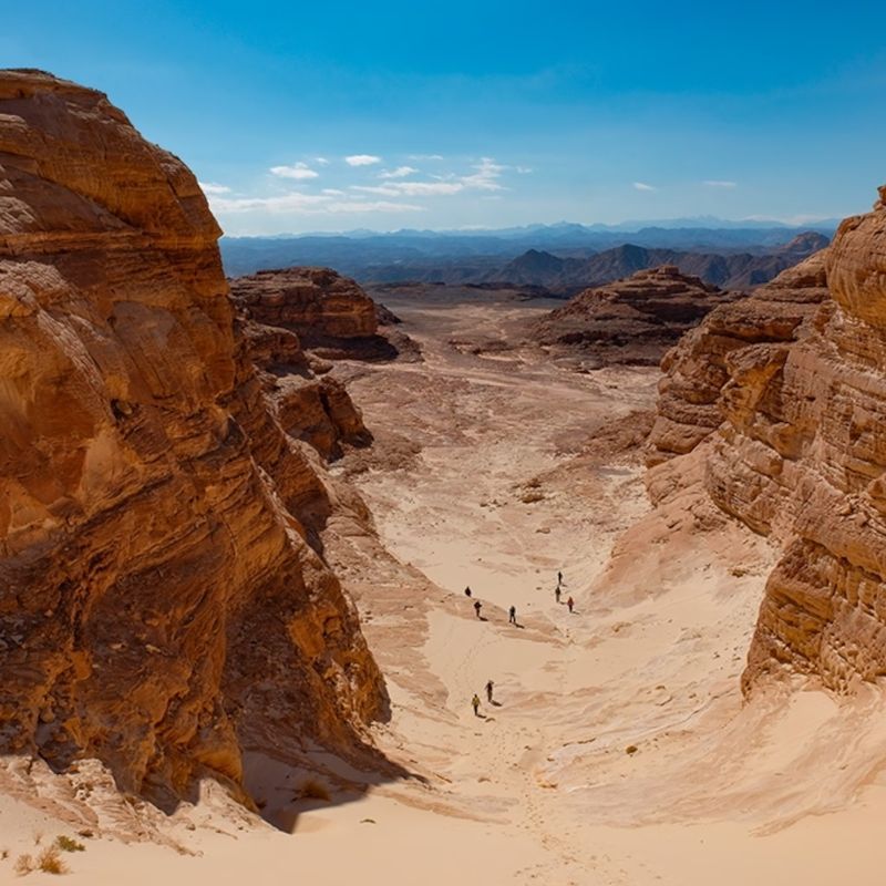 Experience the vast and rugged beauty of Egypt’s Sinai Peninsula with this captivating aerial view of the Sinai Trail. The image reveals sweeping desert landscapes, winding mountain paths, and dramatic ridgelines, highlighting the raw, untouched scenery that makes this region one of the Middle East’s most unique hiking destinations. The interplay of light and shadow across the terrain enhances the rich earthy tones, creating a striking and immersive scene that captures the spirit of adventure and cultural heritage woven into the landscape.
Inspiration Africa crafts tailor-made journeys to Egypt, offering travellers the opportunity to hike the legendary Sinai Trail, travel alongside Bedouin guides, and experience authentic desert life while exploring one of the region’s most remote and awe-inspiring environments.