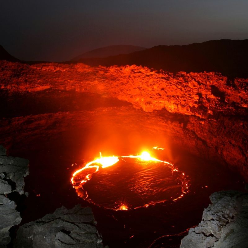 Witness the raw power of nature with this dramatic image of Erta Ale Volcano in Ethiopia, one of the few continuously active lava lakes in the world. The photo captures the glowing molten lava, rugged volcanic slopes, and otherworldly landscape of the Danakil Desert, showcasing the intense and awe-inspiring environment surrounding this iconic volcano. Erta Ale offers a truly unique adventure, where the forces of the Earth are visible in their most elemental form.
Inspiration Africa designs tailor-made journeys to Ethiopia, providing safe and unforgettable experiences to witness Erta Ale and explore the striking volcanic landscapes of the Danakil Depression, one of Africa’s most extraordinary natural wonders.
