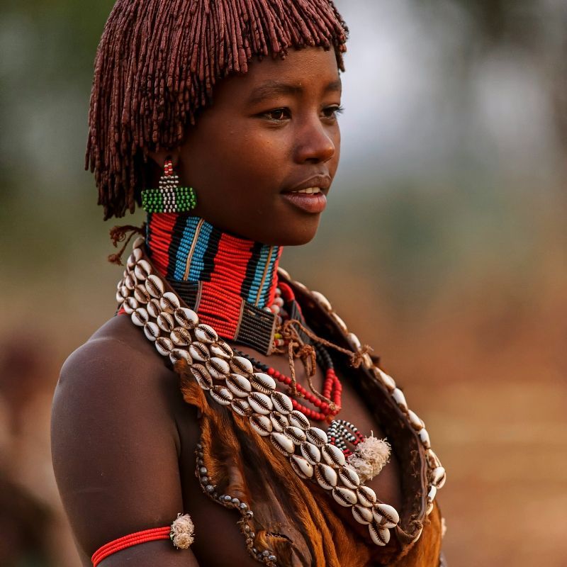 Experience the rich cultural heritage of Ethiopia with this striking image of a Hamer woman dressed in traditional attire. The photo captures the intricate details of her clothing, accessories, and body adornments, reflecting the vibrant identity and proud traditions of the Hamer community. Set against the backdrop of Ethiopia’s stunning landscapes, the scene offers an intimate glimpse into daily life, ceremonies, and the enduring cultural practices that define one of the country’s most distinctive ethnic groups.
Inspiration Africa designs tailor-made journeys to Ethiopia, allowing travellers to engage respectfully with local communities, explore diverse cultural traditions, and experience the unique heritage and vibrant lifestyles of the Hamer and other indigenous peoples.
