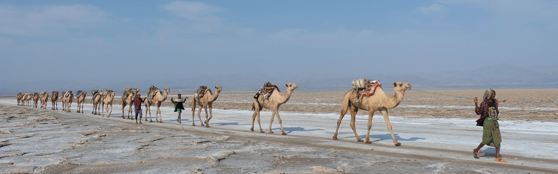 Experience the otherworldly beauty of Ethiopia’s Danakil Desert with Inspiration Africa. Picture camel caravans led by locals in traditional attire crossing vast, sunbaked landscapes — a scene unchanged for centuries. From the salt flats to volcanic craters, this extraordinary region offers raw adventure and cultural immersion like nowhere else on Earth. Inspiration Africa designs bespoke journeys that bring you close to Ethiopia’s timeless traditions and breathtaking desert scenery. Travel with us to discover the Danakil Depression — one of the most captivating and extreme destinations in Africa