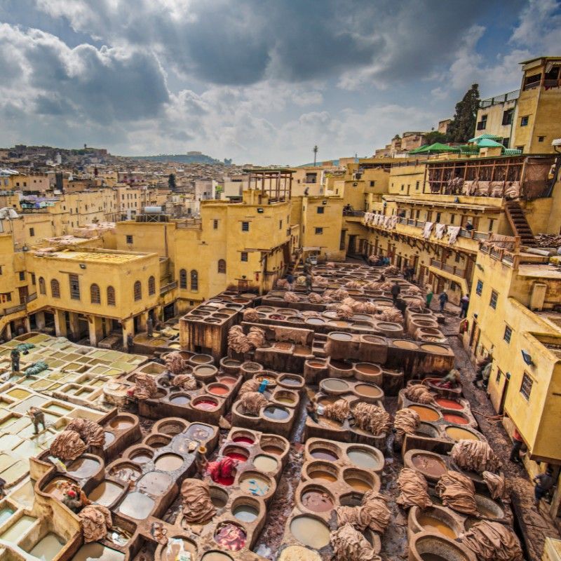 This vibrant image showcases the iconic Chaouwara tanneries in Fez, Morocco, where centuries-old traditions of leather dyeing come to life in a kaleidoscope of color. Nestled in the heart of the ancient medina, the tanneries offer a fascinating glimpse into Morocco’s artisanal heritage. Inspiration Africa arranges personalized journeys to Fez, including guided medina tours, cultural encounters, and visits to traditional workshops. Whether you're exploring hidden alleys or observing leather artisans at work, every detail is carefully planned. Discover the soul of Morocco with Inspiration Africa—your gateway to immersive and authentic travel experiences in Fez and beyond.