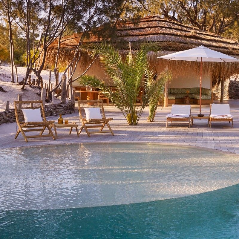 The swimming pool at Kisawa Sanctuary in the Bazaruto Archipelago, Mozambique, is captured in this breathtaking travel photograph, showcasing a serene infinity-style pool overlooking the turquoise waters of the Indian Ocean. Framed by lush tropical vegetation and elegant thatched villas, the pool area invites guests to relax while taking in uninterrupted panoramic sea views. The calm water mirrors the sky above, enhancing the sense of tranquility and seamless connection to the natural surroundings. The scene conveys luxury, privacy, and harmony with the pristine coastal environment, highlighting Kisawa Sanctuary as a world-class island retreat in one of Mozambique’s most spectacular destinations. Inspiration Africa specializes in bespoke, tailor-made journeys to Mozambique and across Africa, crafting unforgettable travel experiences in extraordinary destinations.
