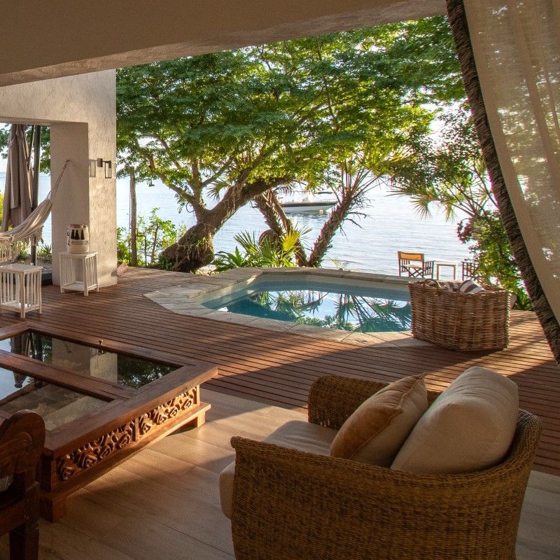 The swimming pool at Shakati Beach Lodge in Mozambique is captured in this serene travel photograph, showcasing a tranquil oasis set amid lush tropical vegetation and just steps from the Indian Ocean. The calm, turquoise waters of the pool reflect the surrounding palms and sun loungers, creating a relaxing and inviting atmosphere. Shaded areas and comfortable seating provide spaces for rest and leisure, while the natural design and open layout emphasize harmony with the beach environment. The scene conveys peace, casual luxury, and a strong connection to Mozambique’s pristine coastline, highlighting Shakati Beach Lodge as an ideal retreat for relaxation and seaside escape. Inspiration Africa specializes in bespoke, tailor-made journeys to Mozambique and across Africa, crafting unforgettable travel experiences in extraordinary destinations.
