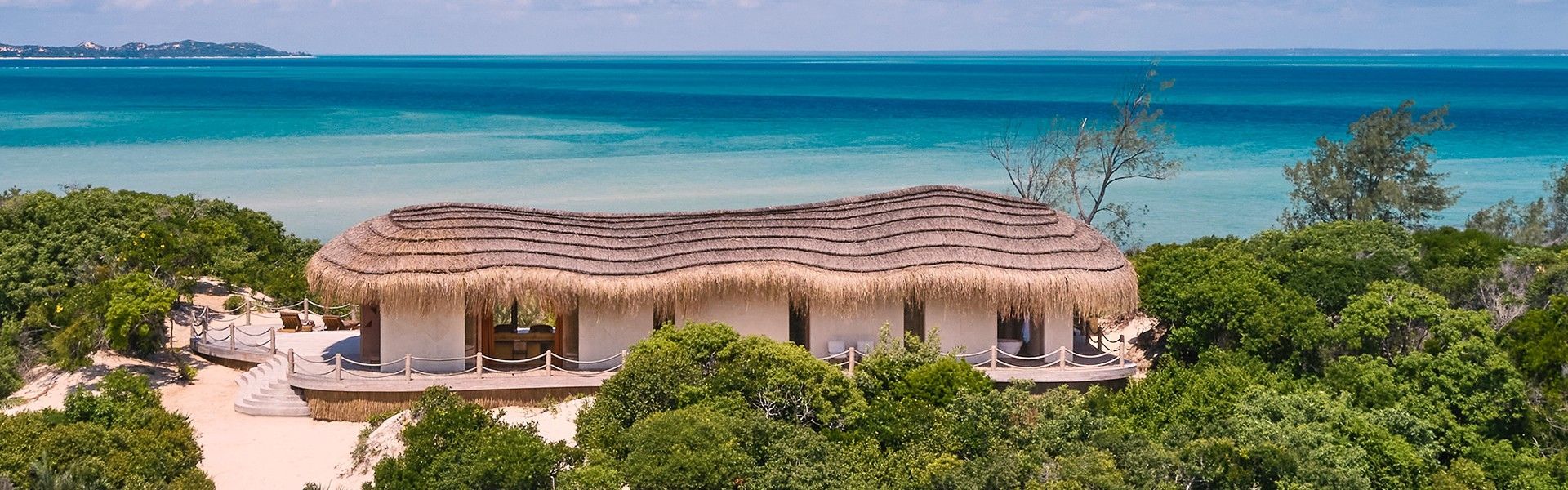 Kisawa Sanctuary in the Bazaruto Archipelago, Mozambique, is captured in this breathtaking aerial travel photograph, showcasing the private island sanctuary surrounded by the turquoise waters of the Indian Ocean. The pristine beaches, lush tropical vegetation, and thatched luxury villas blend seamlessly into the natural environment, creating a sense of harmony and exclusivity. Coral reefs and shallow sandbanks visible through the crystal-clear water emphasize the island’s rich marine life and spectacular seascape. The scene conveys serenity, privacy, and natural beauty, highlighting Kisawa Sanctuary as a world-class, immersive island escape in one of Mozambique’s most remarkable coastal destinations. Inspiration Africa specializes in bespoke, tailor-made journeys to Mozambique and across Africa, crafting unforgettable travel experiences in extraordinary destinations.
