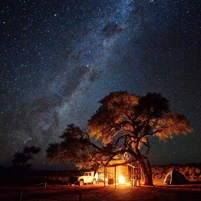 Discover the amazing night sky of Namibia while camping in miles out in the NamibRand desert.