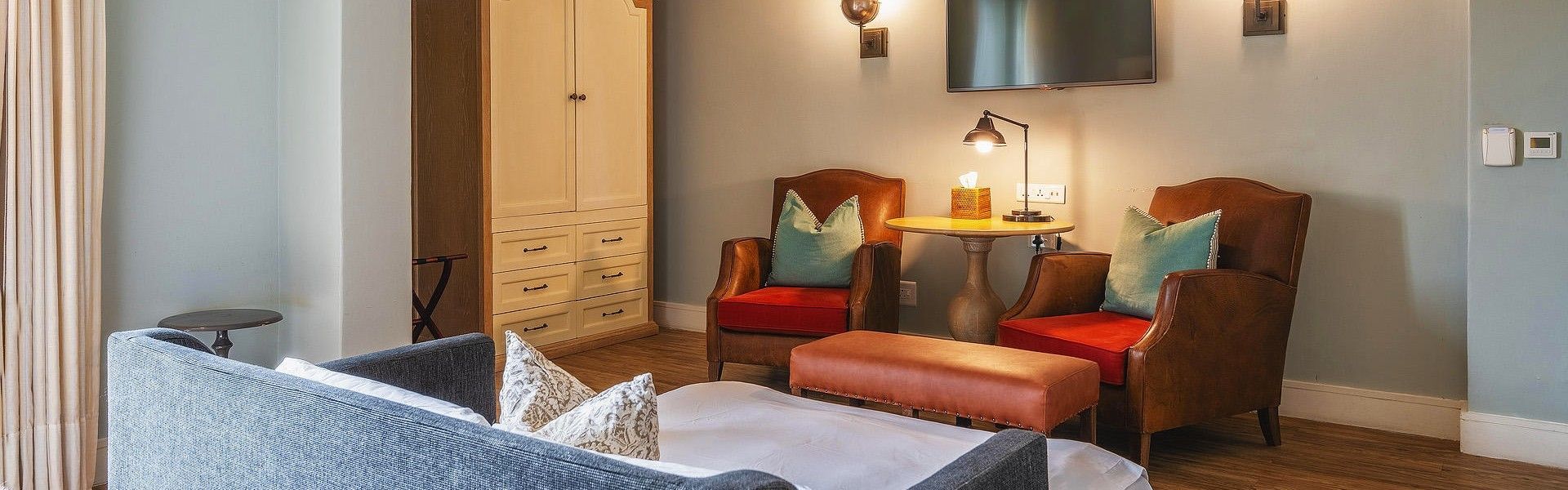 The elegantly decorated interior of a bedroom at Strand Hotel Swakopmund, Namibia, is captured in this inviting travel photograph, highlighting a harmonious blend of modern comfort and coastal charm. Soft, neutral tones, carefully chosen furnishings, and luxurious bedding create a serene, welcoming atmosphere, while natural light filters through large windows to illuminate the space. Subtle décor details and thoughtful design elements emphasize comfort, style, and attention to guest experience. The view outside hints at Swakopmund’s unique seaside location, connecting the interior with Namibia’s coastal environment. Inspiration Africa curates bespoke, tailor-made journeys to Namibia and across Africa, offering stylish accommodations and immersive experiences in remarkable destinations.
