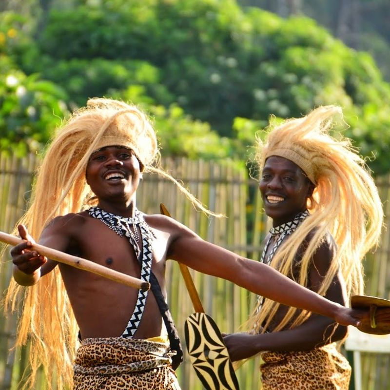Two young warrior dancers in traditional dress perform with striking intensity in Rwanda, captured mid-movement against a backdrop of rolling hills. Their costumes, rhythms, and expressions reflect centuries of cultural heritage passed through generations. Moments like this reveal Rwanda’s deep artistic traditions, often experienced during local festivals or village visits. Inspiration Africa organizes tailor-made travel to Rwanda, offering opportunities to engage with communities, witness traditional dance, and explore the cultural richness beyond the country’s well-known wildlife. Travel with us to discover Rwanda through its people, stories, and vibrant living traditions woven into daily life.
