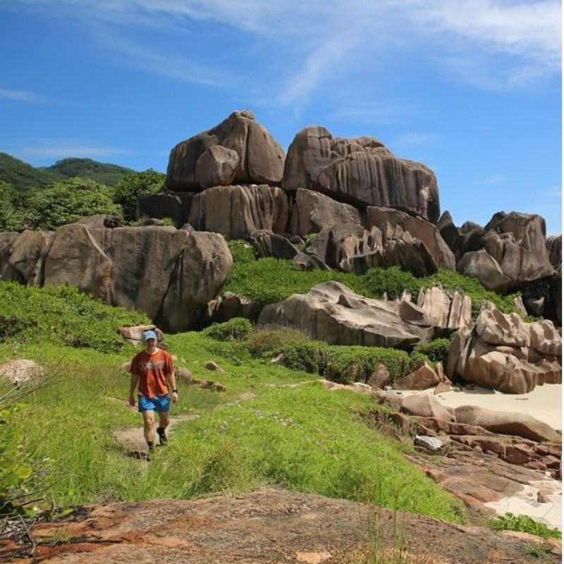 Hiking to Anse Major on Mahé Island in the Seychelles offers a scenic trail through lush forests, granite formations, and panoramic coastal views