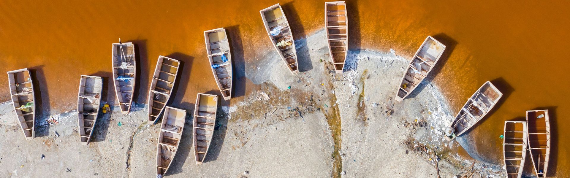 The striking pink waters of Lake Retba (Lac Rose) in Senegal, a unique natural wonder featured in bespoke travel experiences by Inspiration Africa.