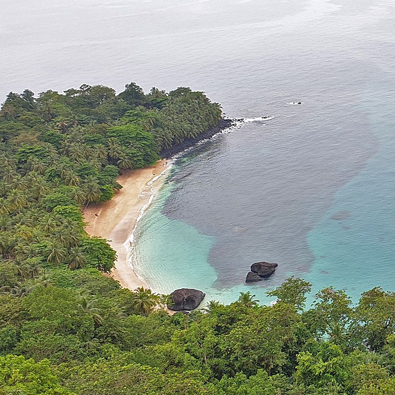 Discover the raw, untouched beauty of São Tomé and Príncipe. This spectacular aerial photo captures the contrast between the intense, rich turquoise water and the island's dramatic, towering mountains blanketed in dense, lush green vegetation. Príncipe is a truly unique, unspoiled tropical paradise. Inspiration Africa specializes in designing your bespoke, tailor-made trip to explore this incredible island and other extraordinary destinations across Africa. Start planning your unique equatorial adventure with us!
