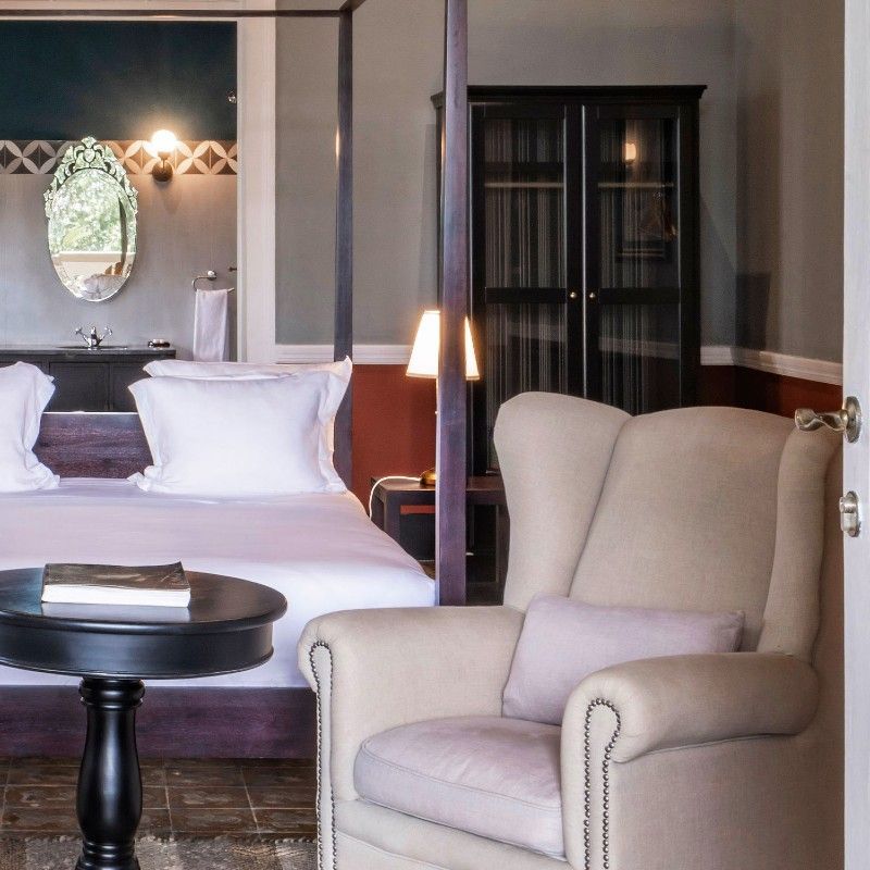 The beautifully decorated interior of Roça Sundy in São Tomé and Príncipe is showcased in this elegant travel photograph, highlighting a space that blends colonial charm with modern comfort. Rich wooden furnishings, vibrant textiles, and carefully curated décor create a warm and inviting atmosphere, while large windows allow natural light to fill the room and offer views of the surrounding tropical gardens and plantation landscape. The design reflects the heritage and history of the estate, combining timeless elegance with a relaxed, luxurious feel. The scene conveys a sense of refinement, comfort, and connection to São Tomé’s unique cultural and natural environment. Inspiration Africa specializes in bespoke, tailor-made journeys to São Tomé and Príncipe and across Africa, crafting unforgettable travel experiences in extraordinary destinations.
